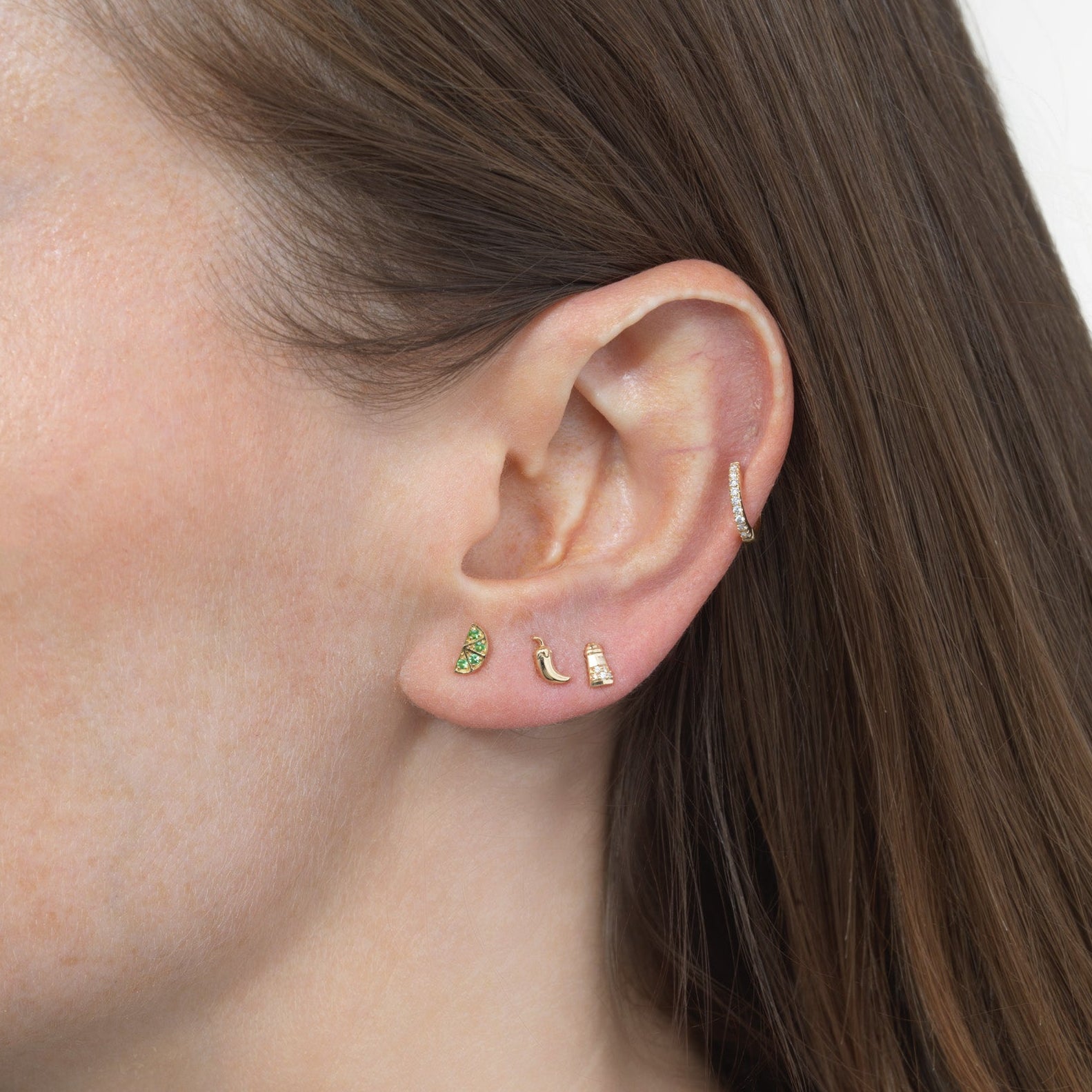 woman wearing shaker lime slice and pepper stud earrings