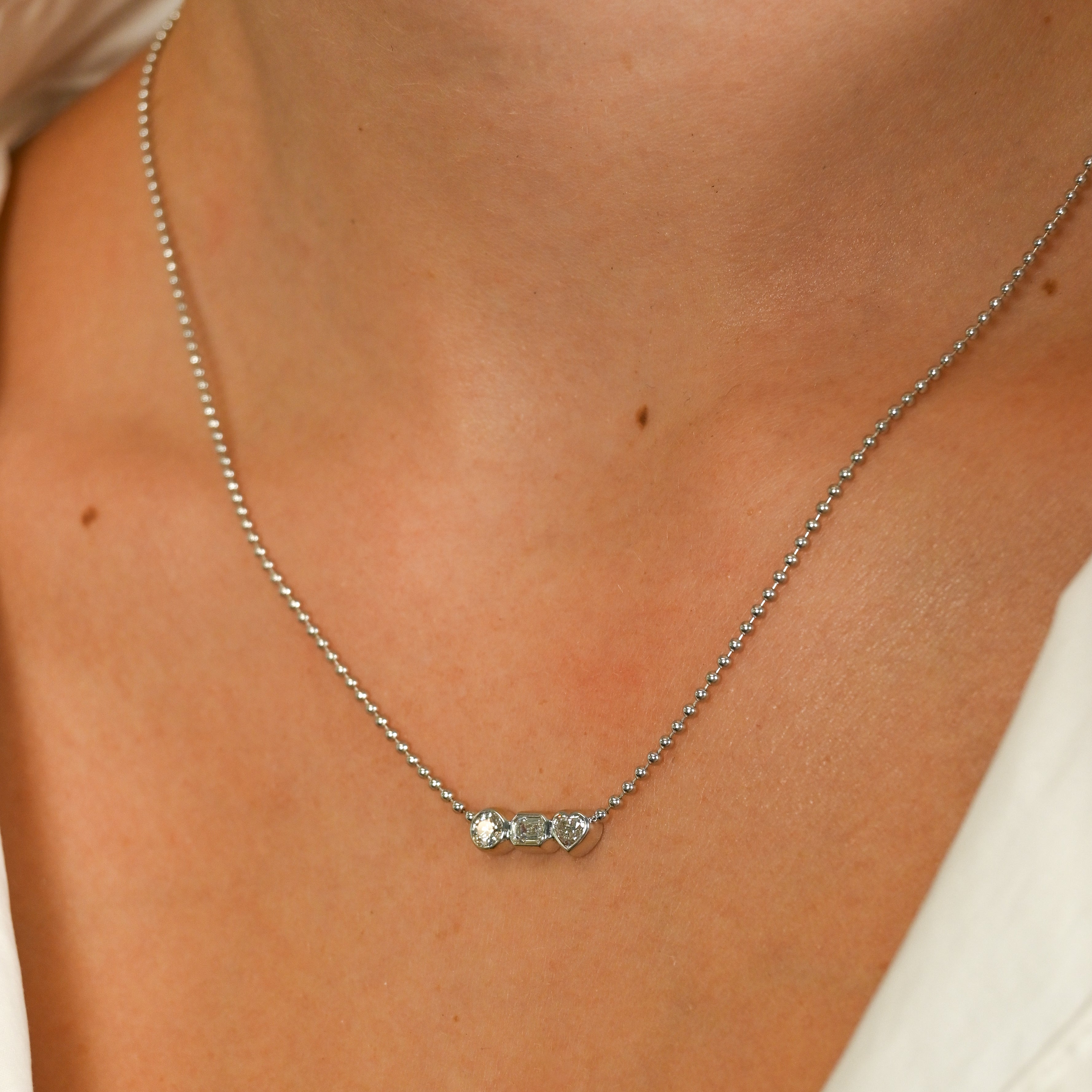 Fancy Bezel Three Stone Bezel Round Emerald Heart Cut Diamond Necklace