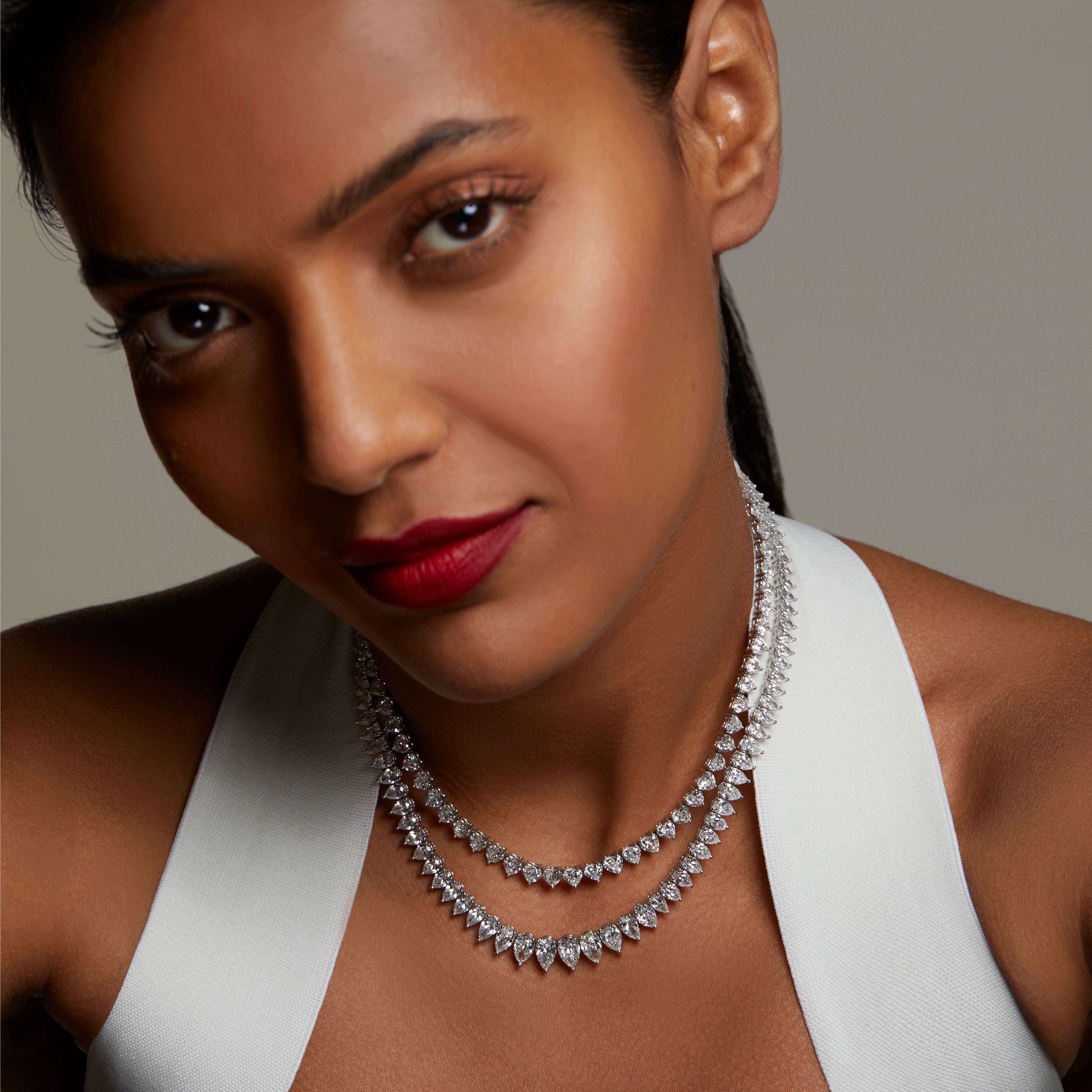 Model wearing diamond necklaces