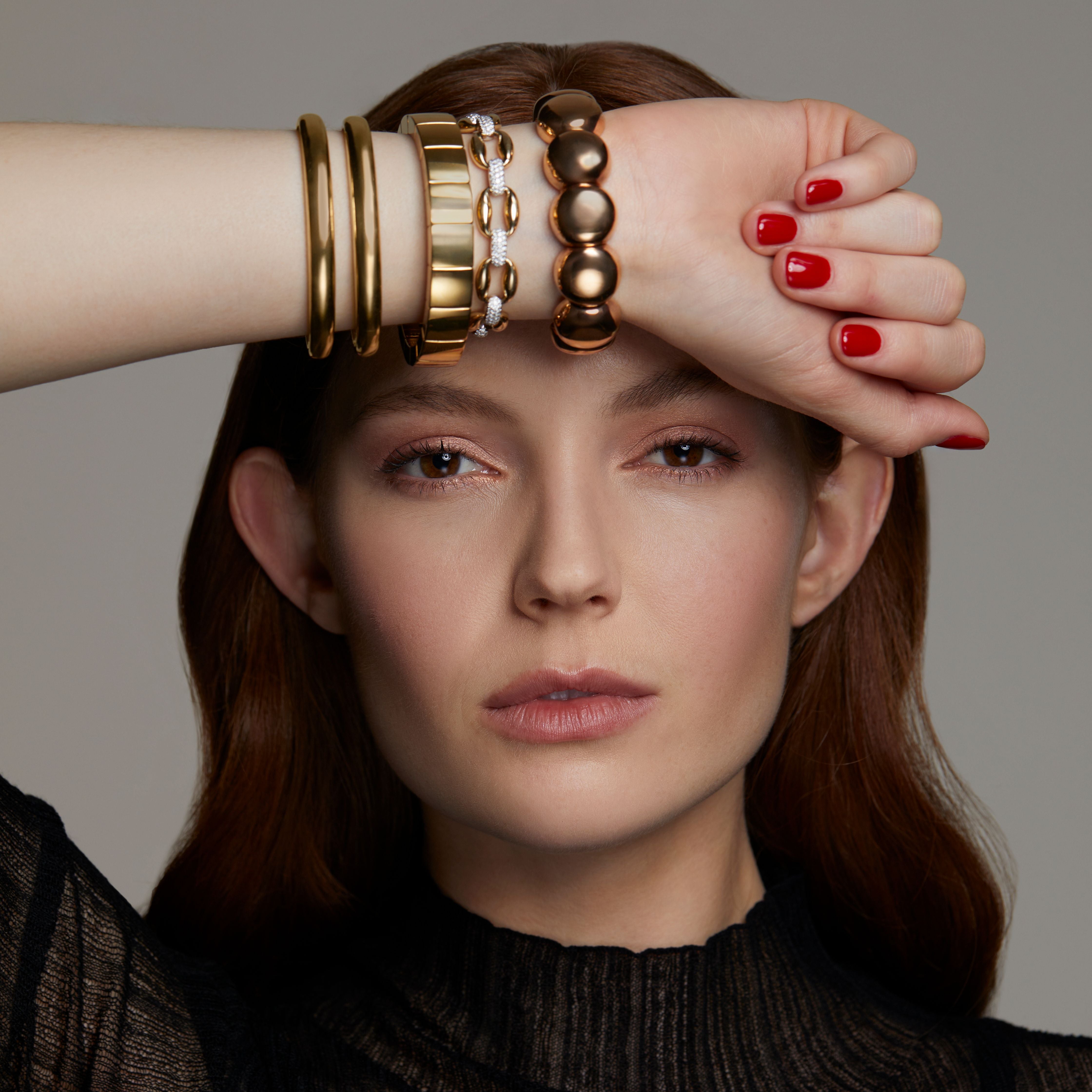 Model wearing gold bangles and bracelets