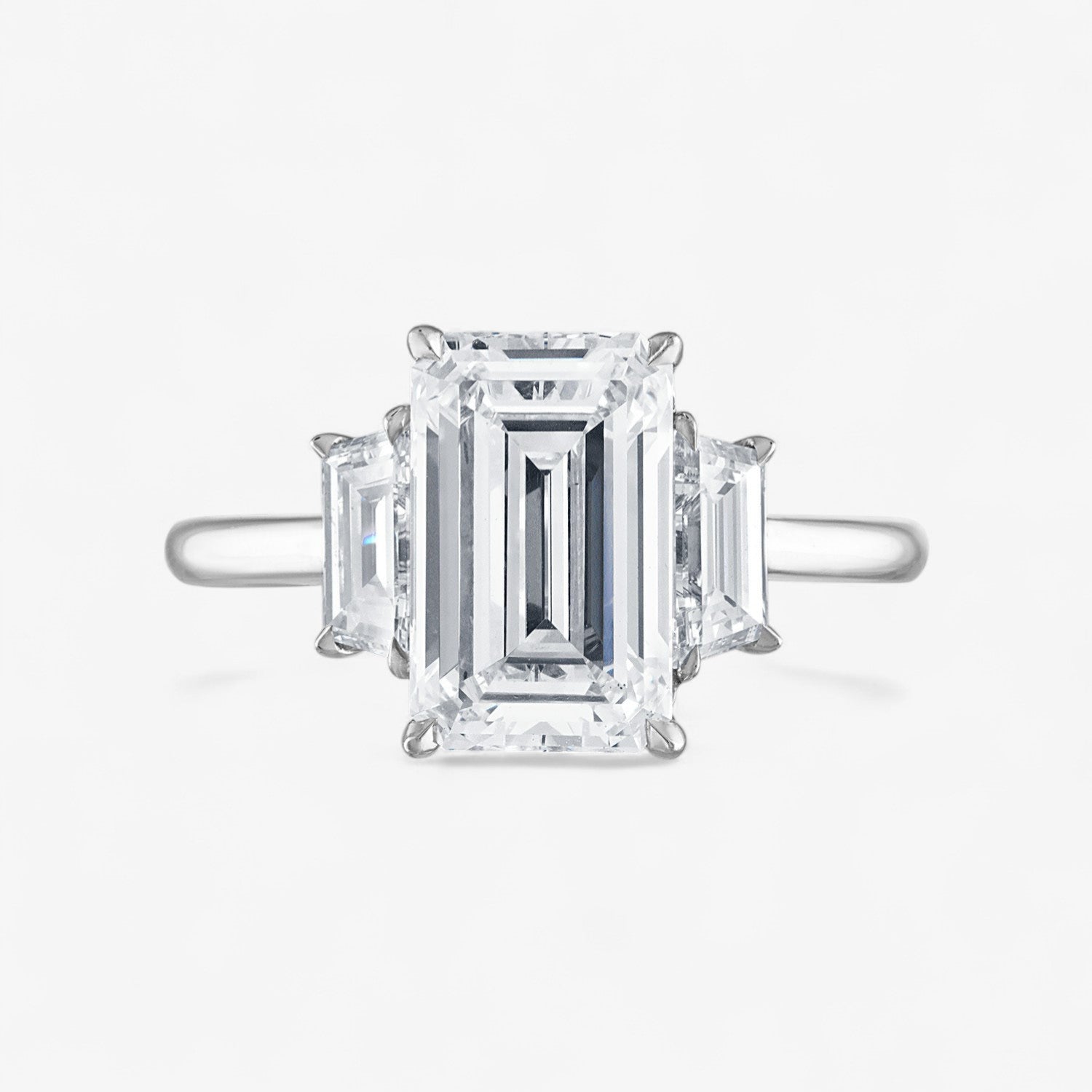 Emerald Cut Three-Stone with Trapezoid Side Stones Engagement Ring