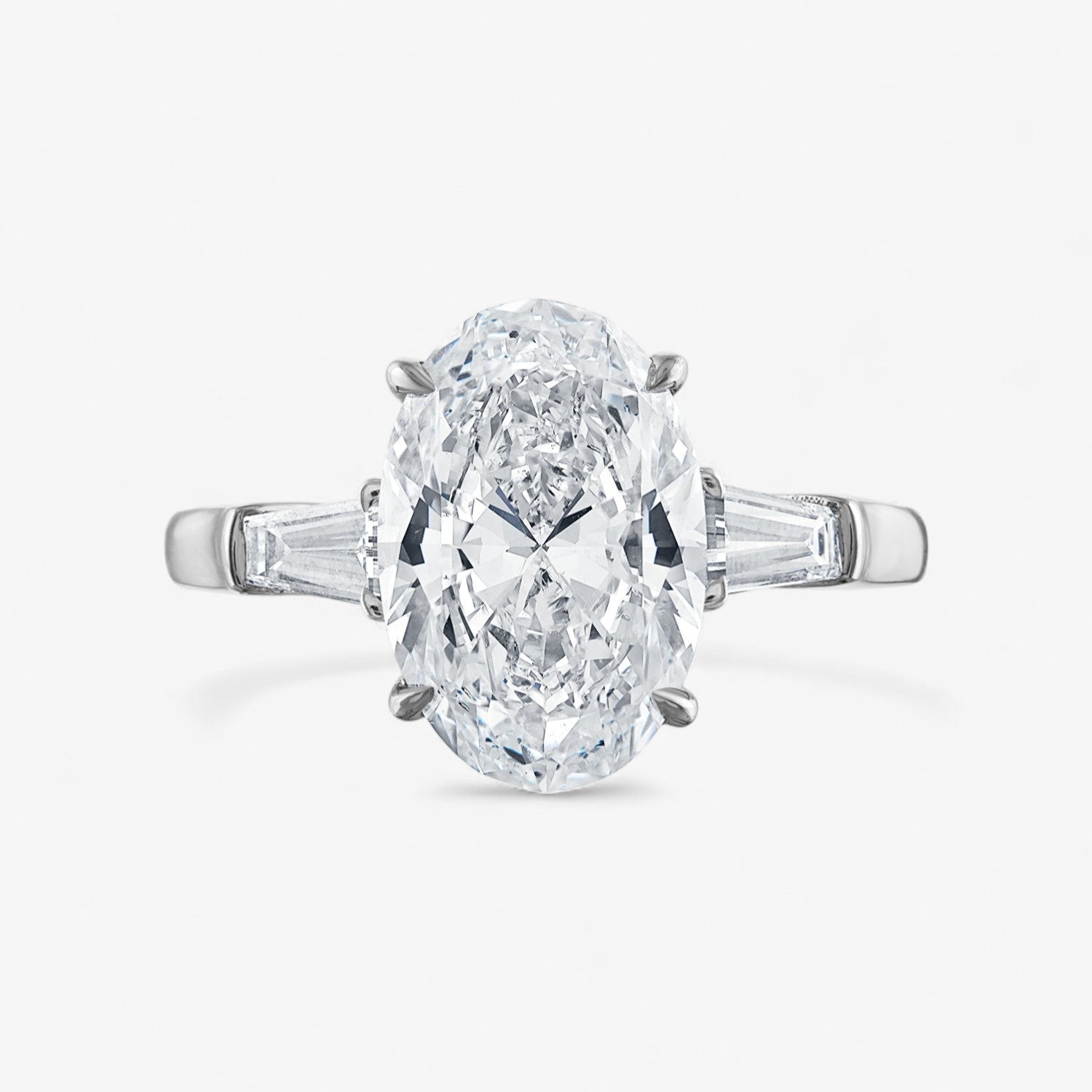 Oval Three-Stone with Tapered Baguette Side Stones Engagement Ring